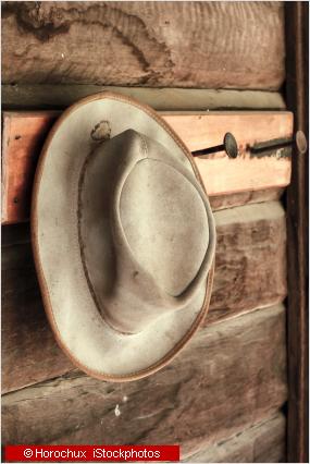 a hat hanging on a shed