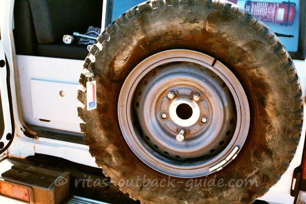 A spare tyre with a h hole.