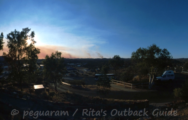 View from a lookout point with fires burning on the horizon