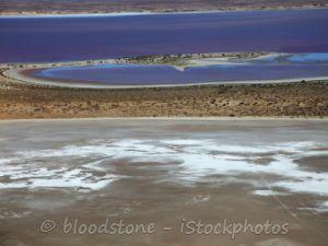 A stream of water meandering into the dry lake