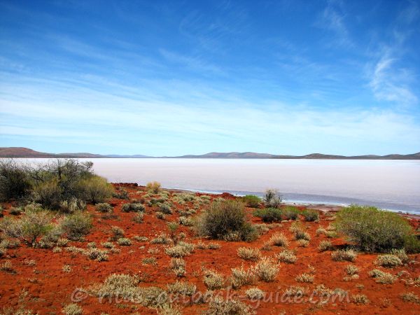 The colours of the Outback - red earth, blue sky, and a shimmering salt lake