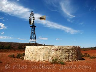 A stone well and windmill