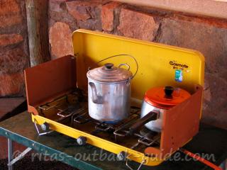 A kettle and a pot on a camping stove