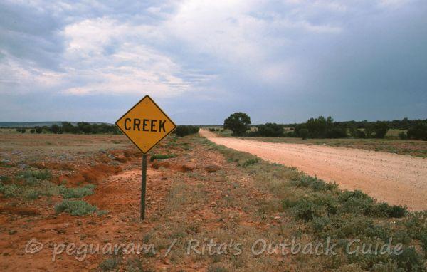 Sign announcing a creek crossing
