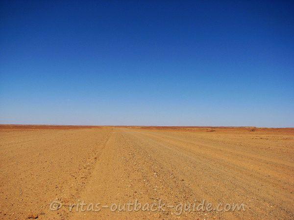 A wide empty dirt road in the Outback